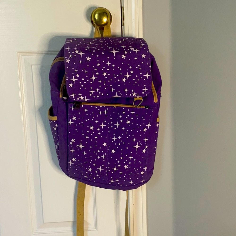 Purple backpack with sparkle designs.